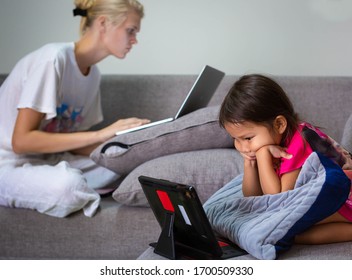 A Family On Their Computers Watching Tv And Working At Home. Technology.