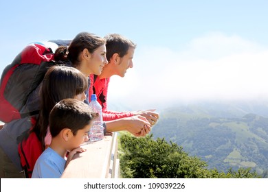 Family On A Trek Day In The Mountain Looking At The View