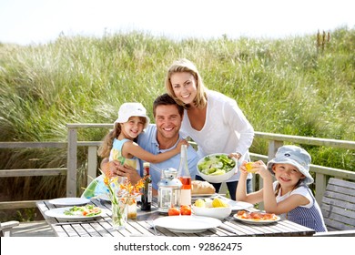 Family On Vacation Eating Outdoors