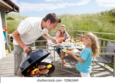 Family on vacation having barbecue