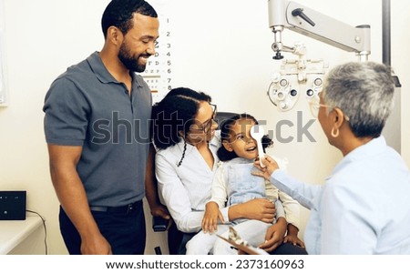 Family, optometry and eye exam with a woman doctor in a clinic to see a patient for vision assessment. Mother, father and daughter at the optometrist for an appointment to test eyesight for children