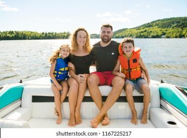 Family Out Boating Together Having Fun On Vacancy