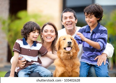 Family Outdoors With A Dog Looking Very Happy