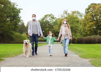 Family, Pandemic And Health Concept - Mother, Father And Little Daughter Wearing Face Protective Medical Mask For Protection From Virus Disease With Labrador Retriever Dog Walking In Summer Park