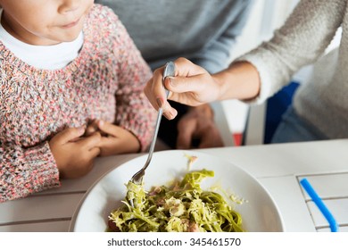 Family, Parenthood, Food And People Concept - Close Up Of Family Eating Pasta For Dinner At Restaurant Or Cafe