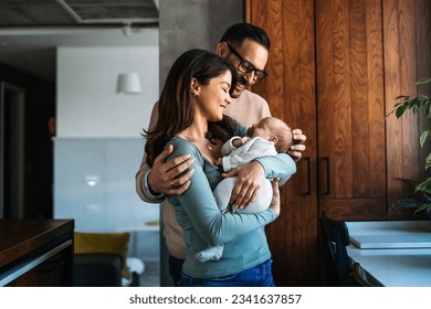 Family, parenthood and people concept. Happy young mother, father with new born baby at home - Shutterstock ID 2341637857