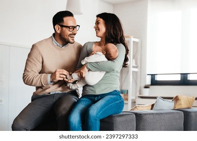 Family, parenthood and people concept. Happy young mother, father with new born baby at home - Powered by Shutterstock