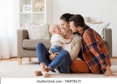 Family, Parenthood And People Concept - Happy Mother, Father With Baby At Home