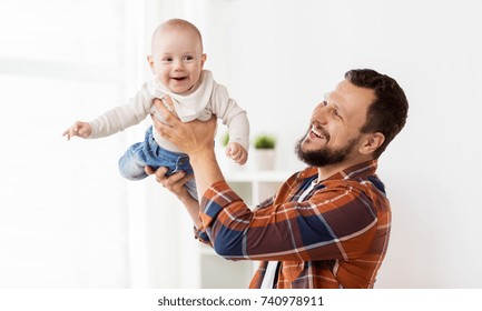 family, parenthood and people concept - happy father playing with little baby boy at home - Powered by Shutterstock