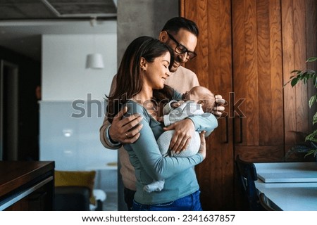 Family, parenthood and people concept. Happy young mother, father with new born baby at home