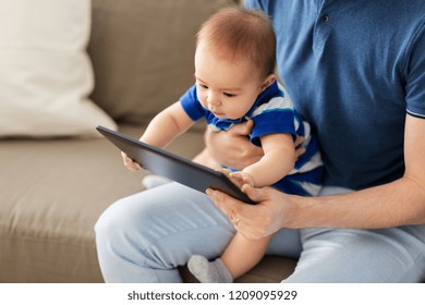 family, parenthood and technology concept - happy asian baby boy and father with tablet pc computer at home - Powered by Shutterstock