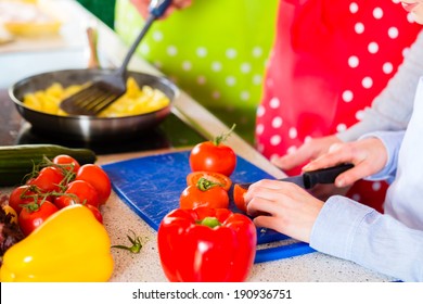 Family - Parents And Child -preparing Healthy Meal In Domestic Kitchen