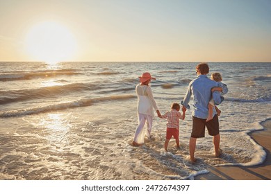 Family, parents and children holding hands on beach trip for holiday fun, vacation and adventure with love. Couple, man and woman and kids on seashore walking with sunset for summer break and support - Powered by Shutterstock