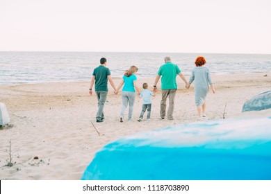 Family, Parents, Grandparents And Grandkids Walking On The Beach