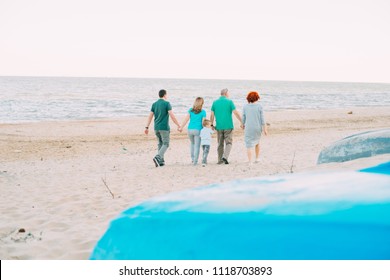 Family, Parents, Grandparents And Grandkids Walking On The Beach