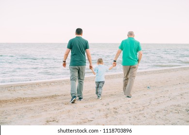 Family, Parents, Grandparents And Grandkids Walking On The Beach