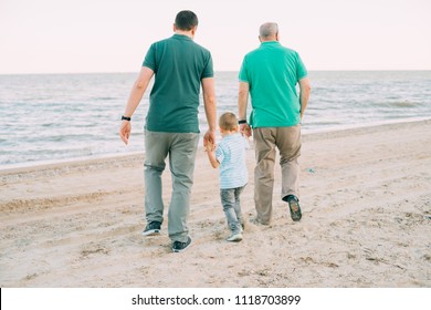 Family, Parents, Grandparents And Grandkids Walking On The Beach