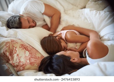 Family, parents and kid sleeping in bedroom for peace, calm and relax together for love in home. Mother, father and girl child in bed to rest for health, dream and cuddle for comfort in house - Powered by Shutterstock