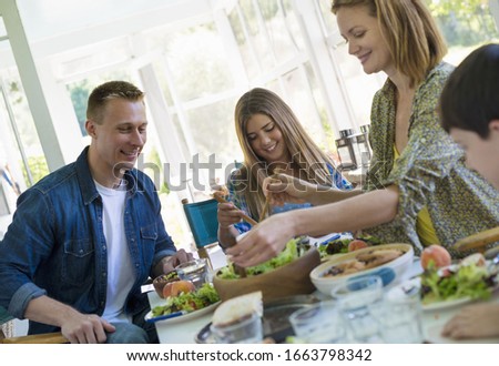 Similar – Gruppe von Freunden, die bei einem Sommergrill kochen.