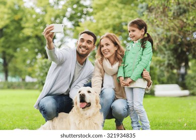 family, pet, animal, technology and people concept - happy family with labrador retriever dog taking selfie by smartphone in park - Powered by Shutterstock