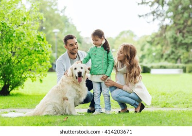 Family, Pet, Domestic Animal And People Concept - Happy Family With Labrador Retriever Dog On Walk In Summer Park