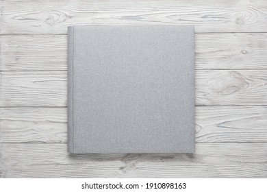 Family Photo Book With Grey Fabric Cover. Stylish Wedding Photo Album On Wooden Background Isolated With Space For Text.
Light Photobook Close Up. Family
Photoalbum  With Beautiful Texture Cover 