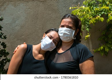 Family Photo Of Mother And Daughter With Face Mask Hugging In The Park