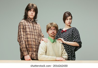 Family Photo In Retro Style, Fashion Of 70s, 80s Years Isolated On Gray Background With Copyspace For Ad. Concept Of Emotions, Facial Expression, Sales. Fashion Models In Vintage Outfits