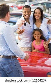 Family Picking Up New Car From Salesman