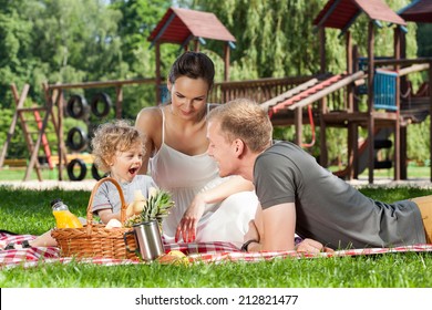 Family Picnic On The Playground During Sunny Day