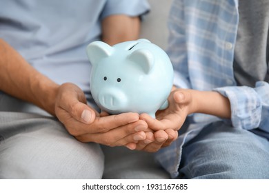 Family With Piggy Bank At Home, Closeup