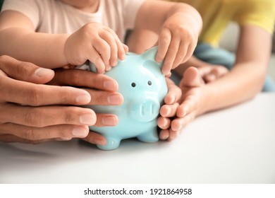 Family With Piggy Bank At Table