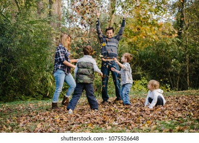 Family planning in autumn leaf pile.