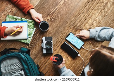 Family Planning Vacation Trip. Girl Searching Travel Destination And Routes Using Navigation Map On Mobile Phone. Woman Writing Journal And Making Notes. Charging Smartphone With Power Bank