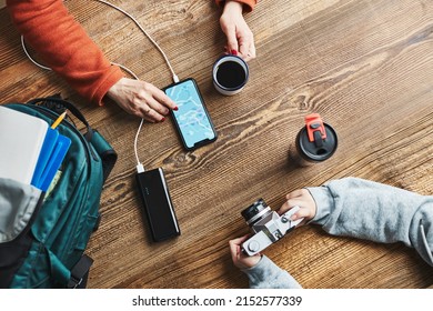 Family Planning Vacation Trip. Woman Searching Travel Destination And Routes Using Navigation Map On Mobile Phone. Girl Setting Up Camera. Charging Smartphone With Power Bank. Using Technology On Trip