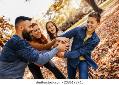 Family playing american football in park. Family and kids, nature concept. - Powered by Shutterstock