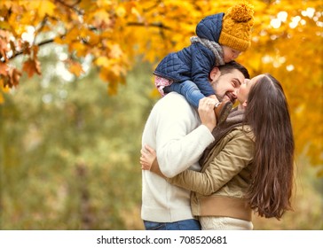 Family Playing In Autumn Park Having Fun