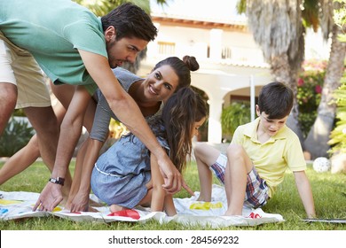 Family Playing Balancing Game In Garden