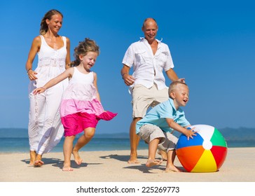 Family Playing Ball On Beach.