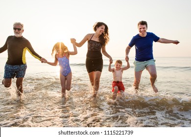 Family Playing At The Beach