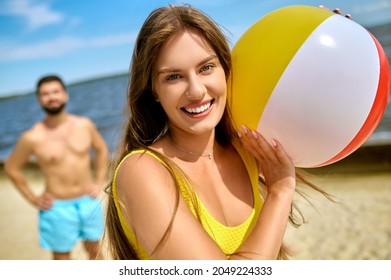 A Family Playing Beach Volleyball And Feeling Happy