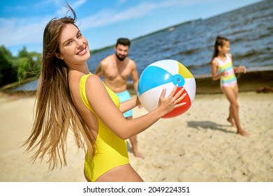 A Family Playing Beach Volleyball And Feeling Happy