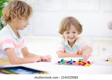 Family Playing Board Game At Home. Kids Play Strategic Game. Little Boy Throwing Dice. Fun Indoor Activity For Summer Vacation. Siblings Bond. Educational Toys. Friends Enjoy Game Night.