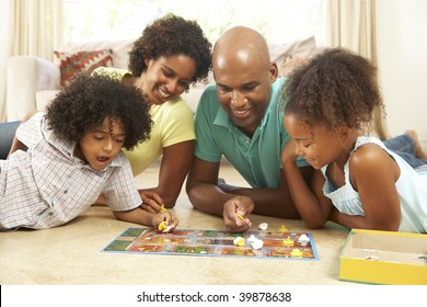 Family Playing Board Game At Home