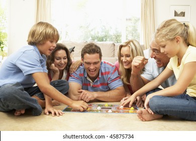 Family Playing Board Game At Home