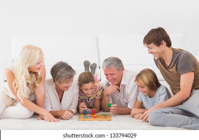 Family Playing Board Games In Sitting Room