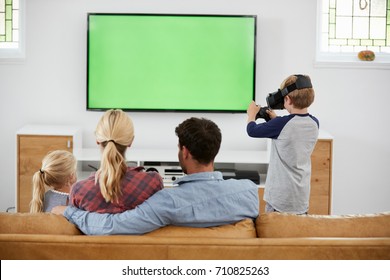 Family Playing Computer Game Using Virtual Reality Headset