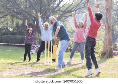 Family playing cricket in park - Powered by Shutterstock