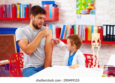 family playing in doctor and patient, father scared of injection