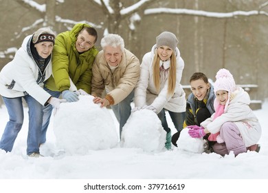 family playing in fresh snow